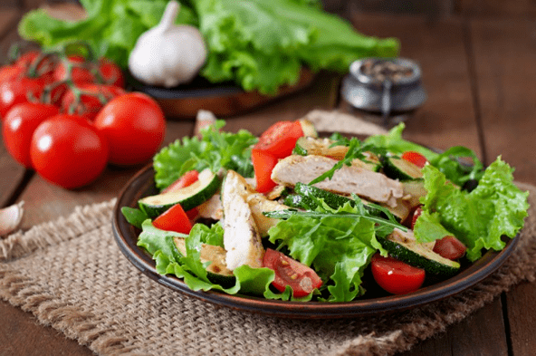 Salad with chicken and vegetables is a great option for a light dinner after a workout. 